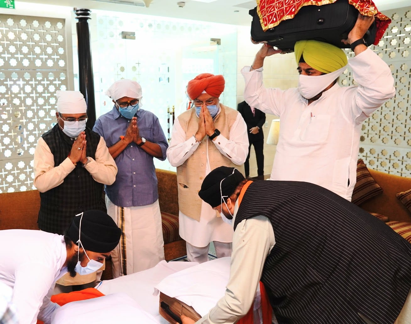 Indian Officials receive the three Swaroops of Shri Guru Granth Sahib from Kabul